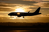 Airplane landing near sunset